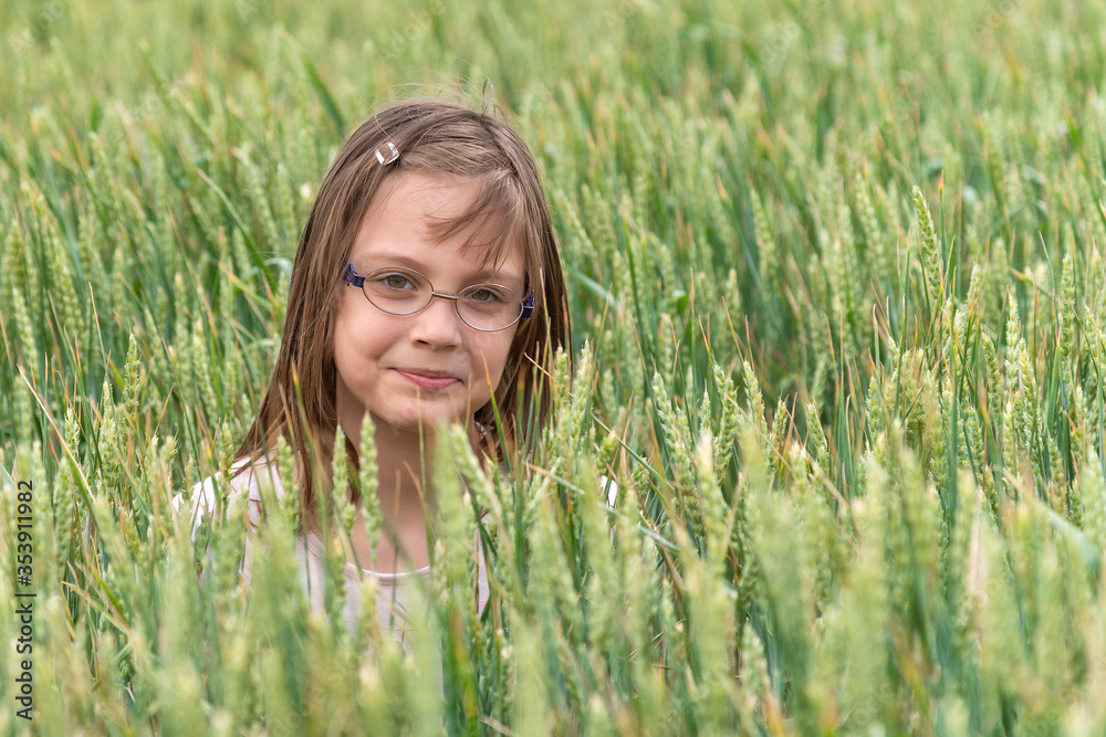 Portrait of a girl in a wheat field. Child in wheat field Portrait of a girl in a wheat field. Child in wheat field