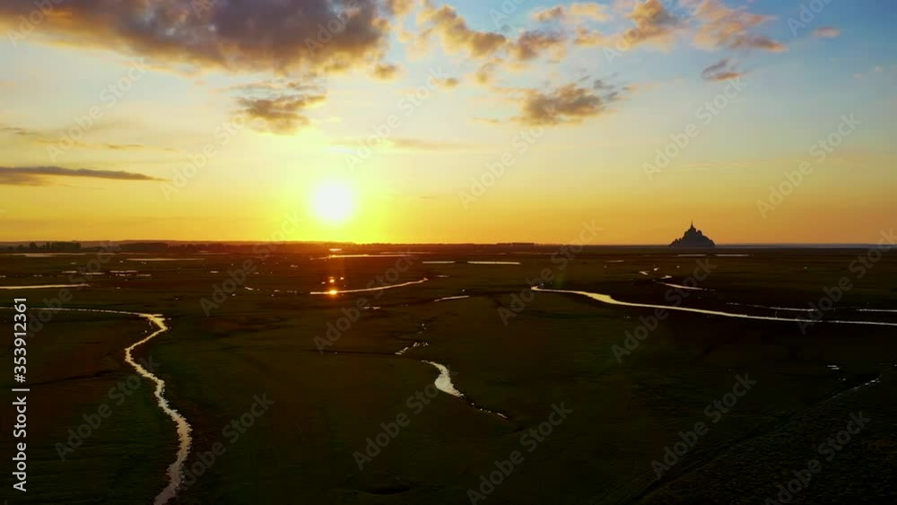The Bay of Le Mont-Saint-Michel with wide marshlands at sunset, France The Bay of Le Mont-Saint-Michel with wide marshlands at sunset, France