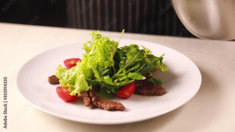 The chef prepares a salad from farm products. In the kitchen of a top restaurant The chef prepares a salad from farm products. In the kitchen of a top restaurant