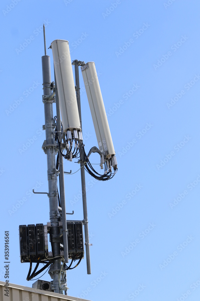 Cellular, mobile phone transmitter tower with blue sky and clouds middle Cellular, mobile phone transmitter tower with blue sky and clouds middle