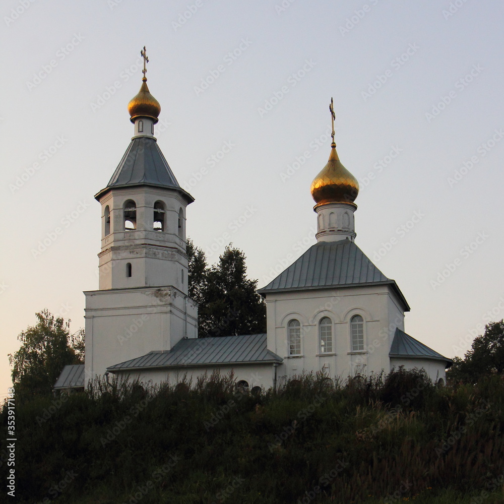 Russia, Moscow region, St. Nicholas Church on the hill in Tishkovo near Vyaz river on a summer evening