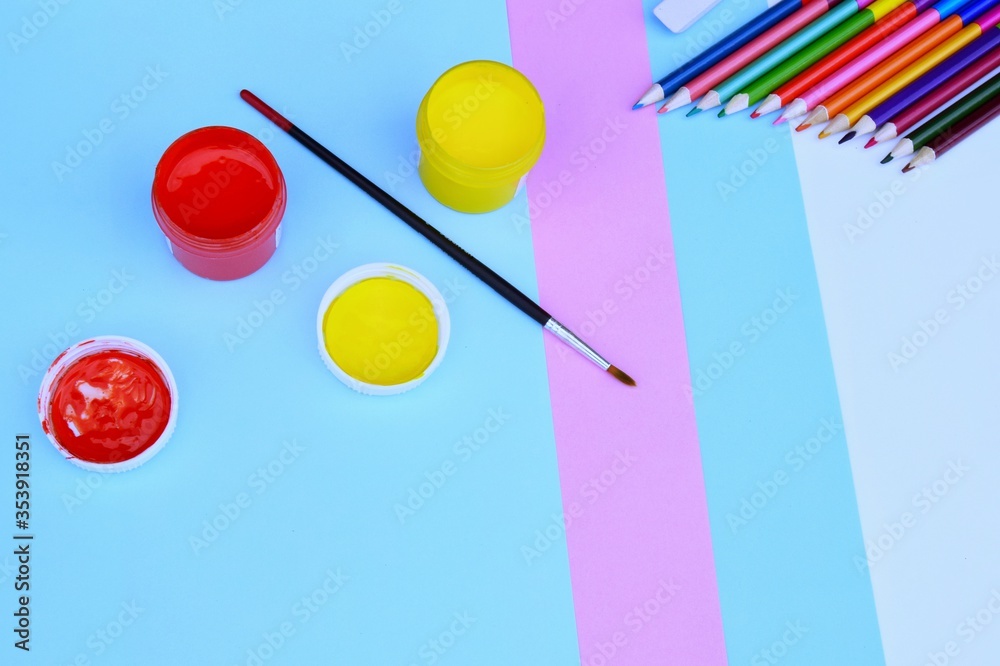 yellow and red acrylic paints with colored pencils on sheets of colored paper. pastel background tones yellow and red acrylic paints with colored pencils on sheets of colored paper. pastel background tones