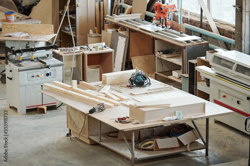 Workbench of furniture factory worker with wooden workpieces