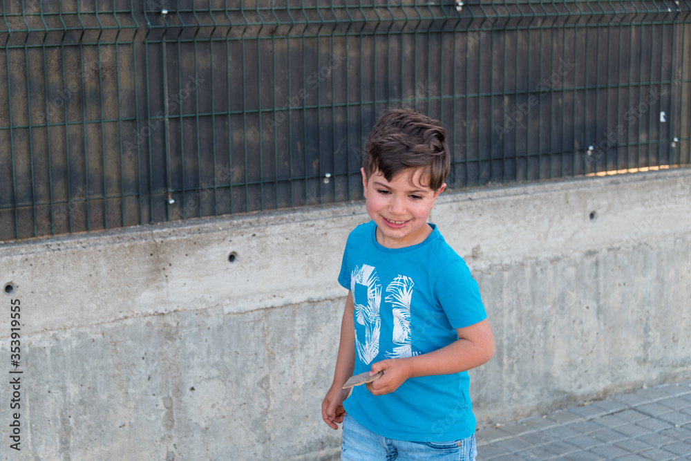 5-year-old boy looking left with blue t-shirt and jeans