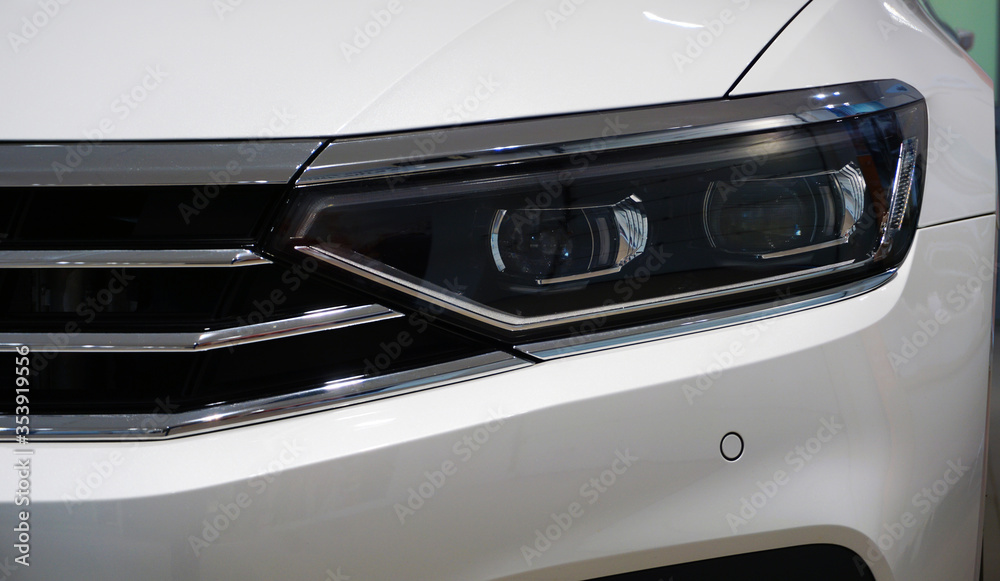 Closeup headlight of a modern luxury car. Design and modern technology in the automotive industry. Sale, maintenance, repair and spare parts. Concept.