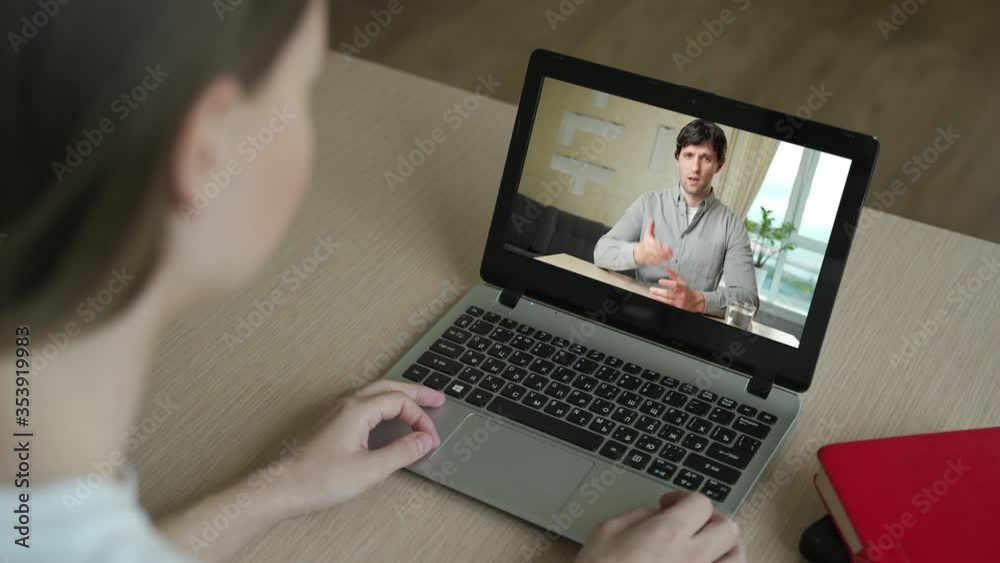 Woman having video chat with colleague at table in office, closeup Woman having video chat with colleague at table in office, closeup
