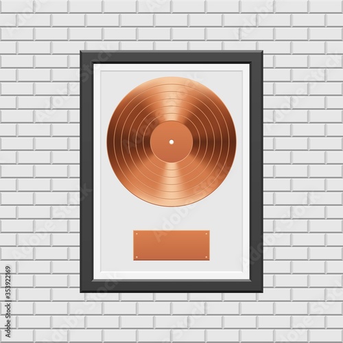 Bronze vinyl record with black frame on white brick wall