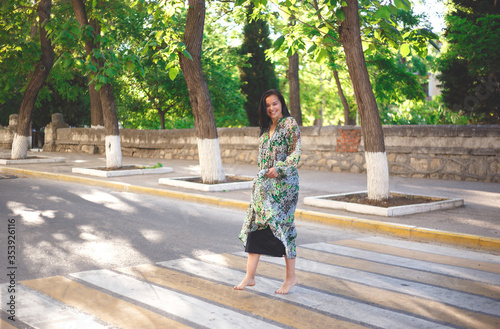 woman in a dress walks barefoot around the city © Aleksandra Iarosh