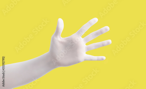 Hand gesture on yellow background poster. Open palm and five fingers.