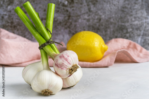 Fresh garlic and lemon on a light background.
Natural vitamins from virus and flu. Copy space