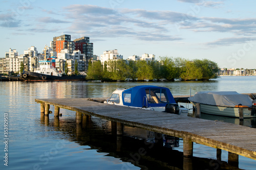 Картината върху платно Boats and calm water at the lake on a summer evening in the city in Sweden