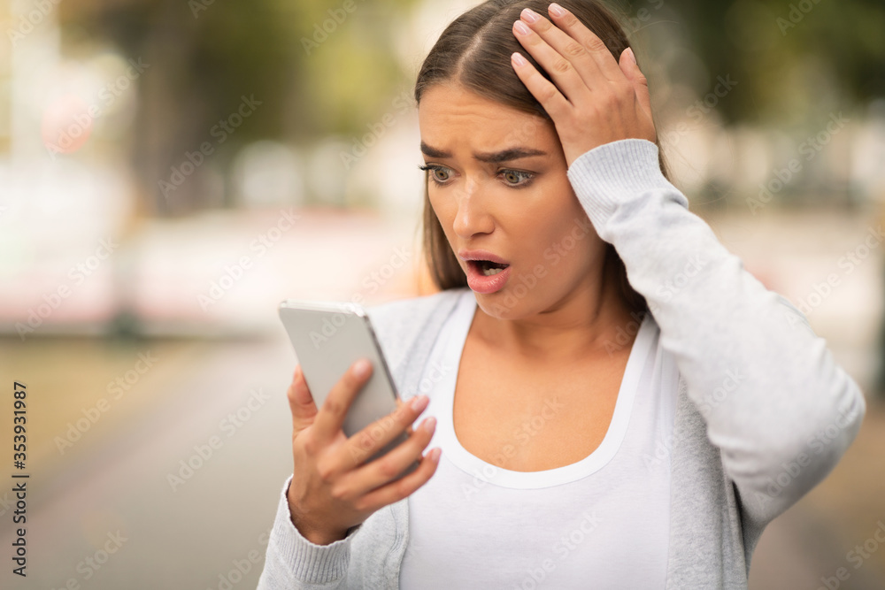 Shocked Girl With Smartphone Reading Bad News Message Standing Outside Shocked Girl With Smartphone Reading Bad News Message Standing Outside