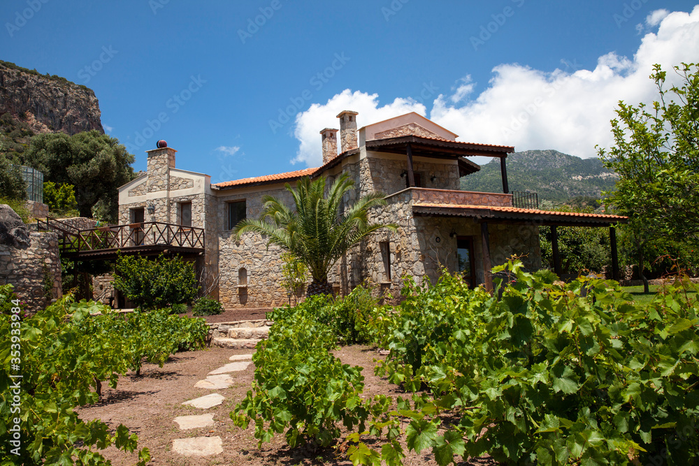A wonderful stone house in green nature, Beautiful house view in the garden with blue sky and mountains. A wonderful stone house in green nature, Beautiful house view in the garden with blue sky and mountains.