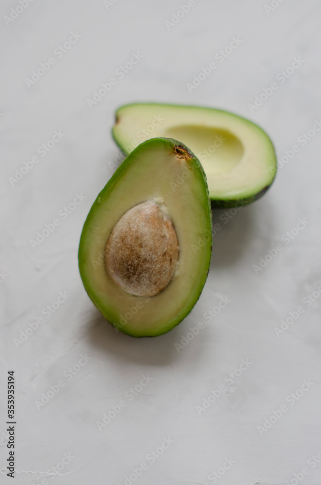 halved avocado on white background