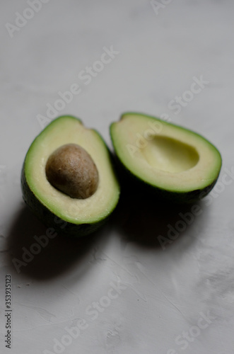 halved avocado on white background