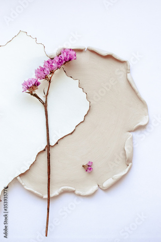 pink flower on a ceramic plate on a white background
