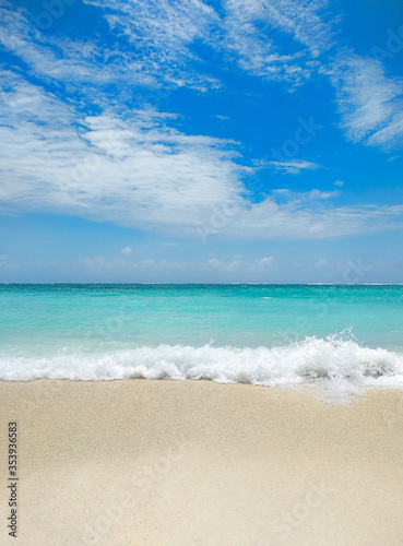 Beautiful beach with white sand  turquoise ocean water and blue sky with clouds in sunny day