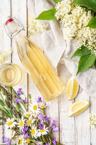Delicious healthy refreshing beverage, sweet elderflower syrup or cordial in a glass bottle