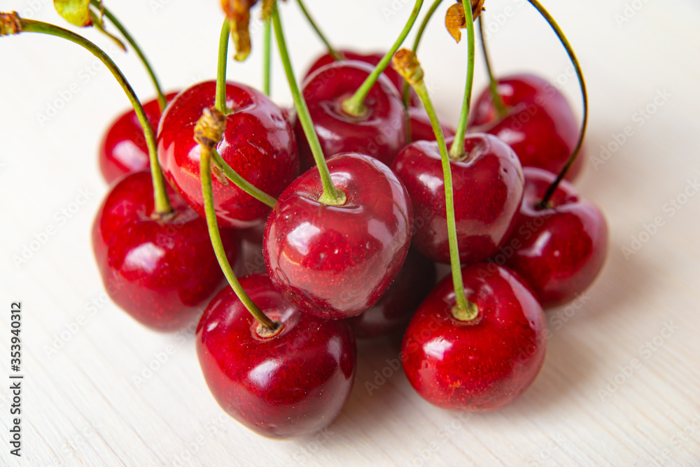 Ripe cherries on wooden surface Ripe cherries on wooden surface