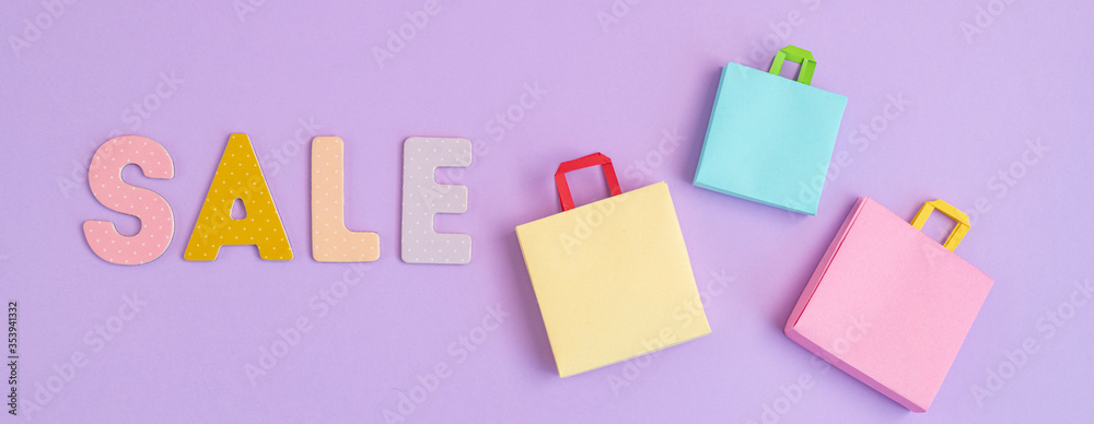 Word Sale and shopping paper bags. Sesonal sale, online deals, discounts, promotion, shopping addiction idea Word Sale and shopping paper bags. Sesonal sale, online deals, discounts, promotion, shopping addiction idea
