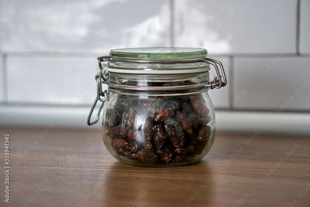 Glass jars with a lid for food on a white shelf. Storage in the kitchen. Containers with bulk products. Transparent container. Glass jars with a lid for food on a white shelf. Storage in the kitchen. Containers with bulk products. Transparent container.