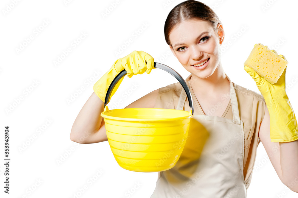 Pretty housewife in yellow rubber gloves holding a sponge and a bucket, getting ready for cleaning, isolated studio portrait on a white background. The concept of housekeeping. Pretty housewife in yellow rubber gloves holding a sponge and a bucket, getting ready for cleaning, isolated studio portrait on a white background. The concept of housekeeping.