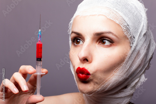 Billede på lærred beautiful young girl, lips painted up with red lipstick, head bandaged with a ba