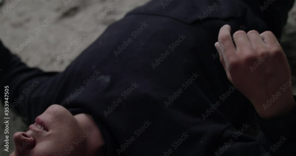 Close view of beaten man, lying on the floor and takes final blow from opponent Close view of beaten man, lying on the floor and takes final blow from opponent