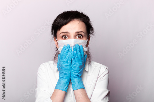 girl in a white shirt, a medical mask and gloves