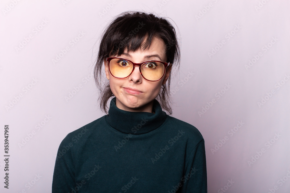 Fototapeta premium girl in a green turtleneck, glasses, portrait on a gray background