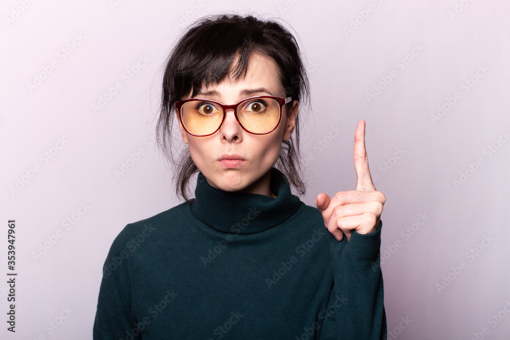 girl in a green turtleneck, glasses, portrait on a gray background girl in a green turtleneck, glasses, portrait on a gray background
