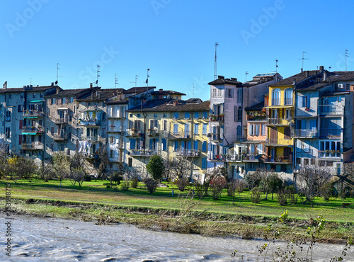 View of the picturesque coloured houses on the river Parma from Ponte di Mezzo, in Parma, on a sunny winter day photo