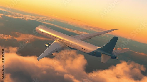 Commercial jet airplane flying above the clouds on sunset
