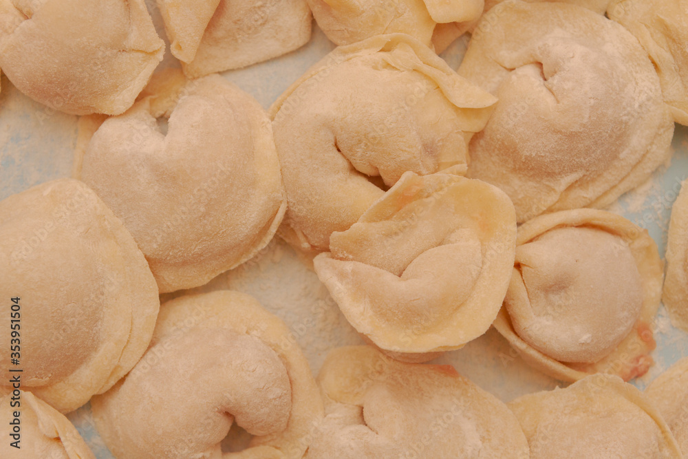 Homemade dumplings are put together on a Board in the kitchen Homemade dumplings are put together on a Board in the kitchen