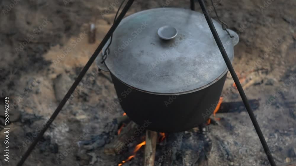 cauldron at the stake. camping in the wood. cooking on the fire. field kitchen. in a pot coming to a boil. a fire built up under a wash pot for scalding water. soup in his bowl. cauldron at the stake. camping in the wood. cooking on the fire. field kitchen. in a pot coming to a boil. a fire built up under a wash pot for scalding water. soup in his bowl.