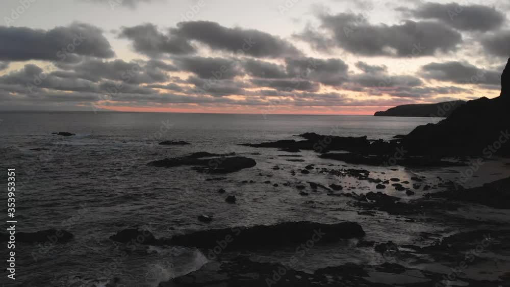 Beautiful aerial view of drone flying above a rocky beach in calheta, Madeira island after sunset, Portugal Beautiful aerial view of drone flying above a rocky beach in calheta, Madeira island after sunset, Portugal