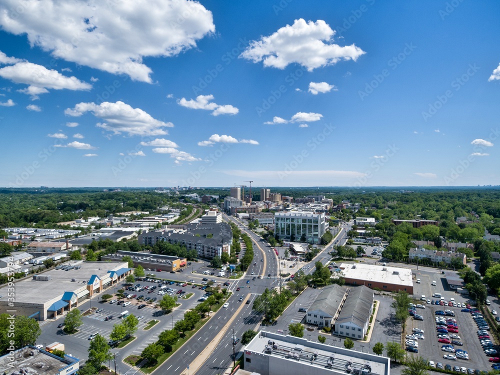 Aerial View of downtown Rockville, Maryland on a sunny day looking south along Hungerford Drive (Route 355). Construction cranes at Rockville Town Center touch the horizon