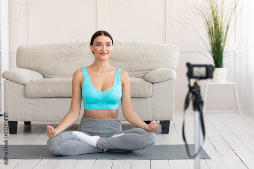 Yoga Blogger Making Video Sitting In Lotus Position At Home