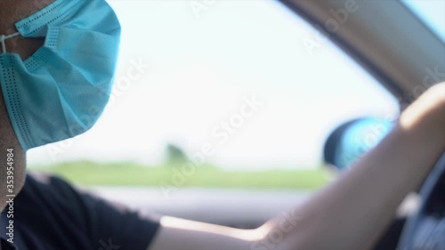 Wallpaper Mural Man with a protective mask driving. Stock video in slow motion of man in protective mask driving a car Torontodigital.ca