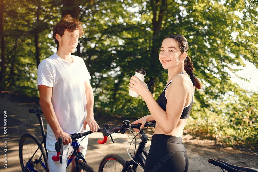 Obraz premium People with a bikes. Couple in a forest. Morning bike ride.