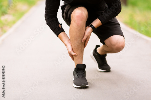 Calf sport muscle injury. Runner with pain in leg