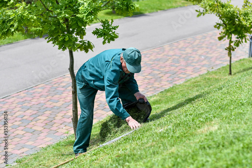Unidentified man removing grass in the park.