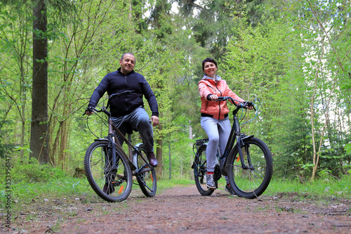 couple on bikes in the forest