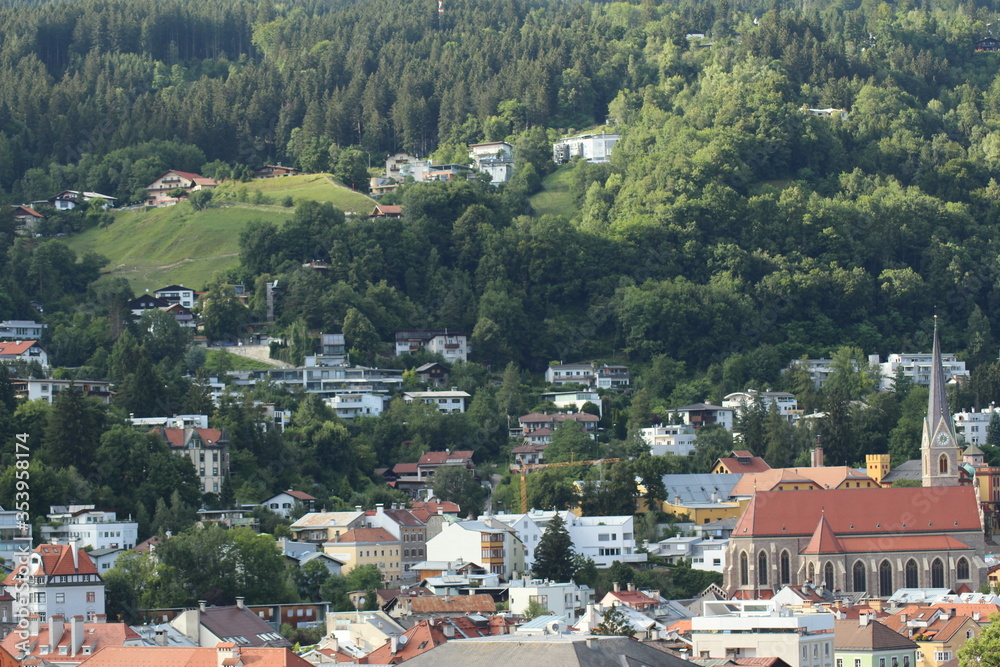 Fototapeta premium Aerial view of Innsbruck city taken from City Tower (Stadtturm) which was built in 1450 in Tirol, Austria. With 51 meters of height, City Tower is located in Old City (Altstadt or Altestadt).