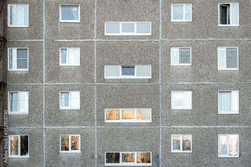 Facade of a grey multi-storey soviet panel building