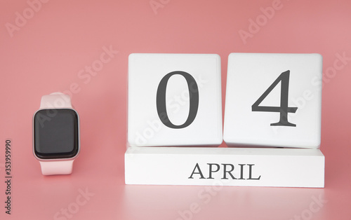 Modern Watch with cube calendar and date 04 april on pink background. Concept spring time vacation.