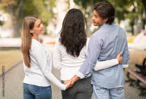 Cheating Boyfriend Holding Hands With Girlfriend's Best Friend Walking Outdoors