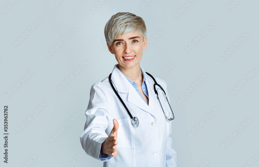 Welcome concept. Woman doctor holds out hand to hello to patient Welcome concept. Woman doctor holds out hand to hello to patient