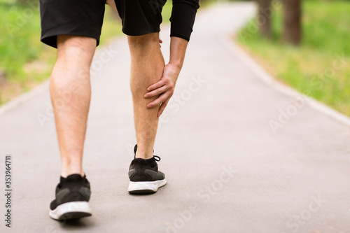 Calf sport muscle injury. Runner with muscle pain in leg