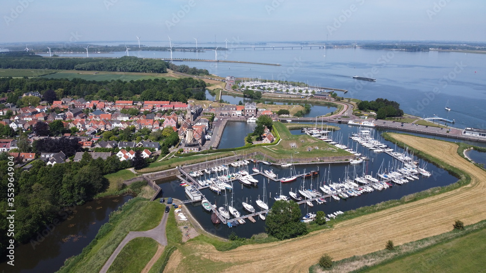 Aerial view of picturesque fortress town of Willemstad in the Netherlands, Brabant. With mill and ports.
